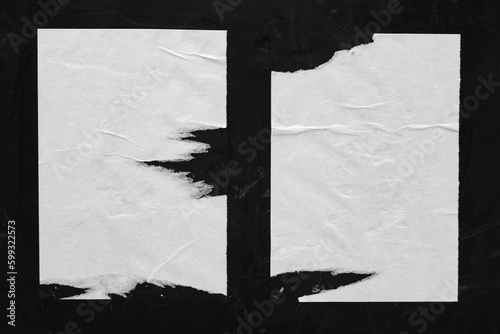 Two white sheets with folds on a black background. photo