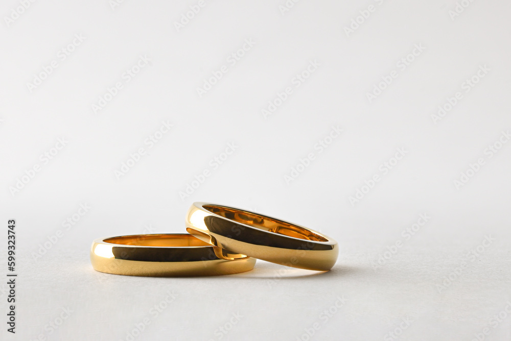 Gold wedding rings lying on white isolated background Gold wedding rings lying on white isolated background