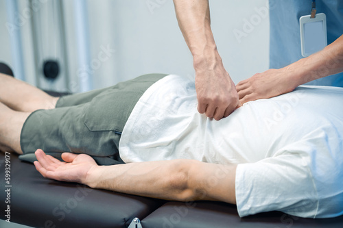 Male patient having a session of rehabilitation back massage