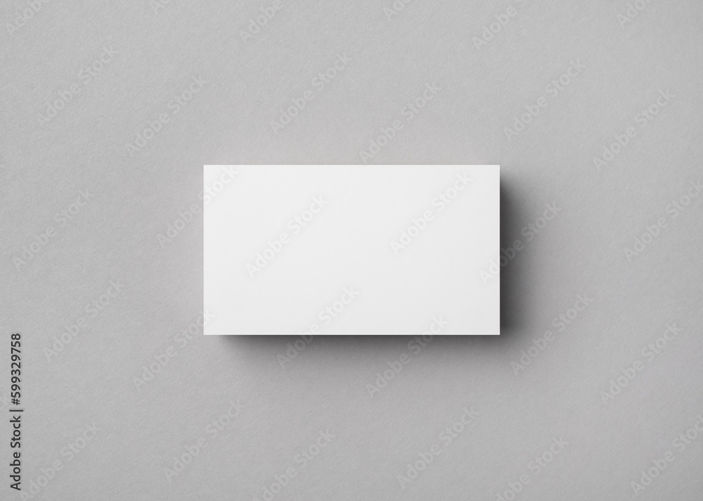Blank business card on gray paper background. Mock-up for branding identity. Flat lay. Blank business card on gray paper background. Mock-up for branding identity. Flat lay.