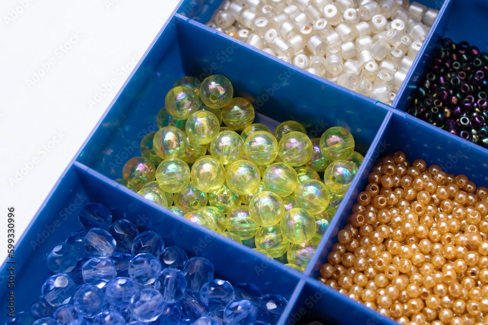 Colorful beads in containers close up, handicrafts Colorful beads in containers close up, handicrafts