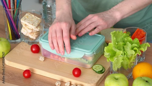 Lunchbox with food for a schoolboy or student. Back to school sign. Toast with salad and vegetables in a food container. The beginning of the school year, mom cooked lunch for the child