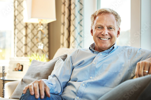 Nothing as enjoyable as a relaxed retirement. Portrait of a happy mature man relaxing on the sofa at home. © Reese/peopleimages.com
