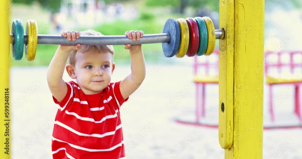 Happy smiling boy having fun on the playground. Kids leisure activity Happy smiling boy having fun on the playground. Kids leisure activity
