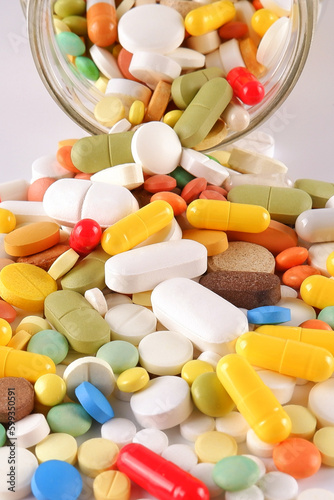 Obraz na plátně A bunch of colorful pills, capsules, poured out of a jar