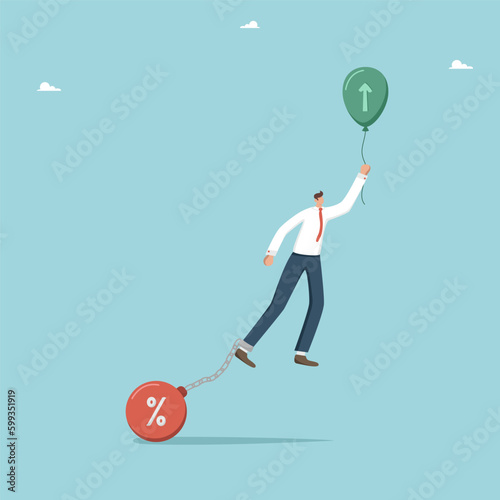 The interest rate on a personal loan or mortgage, debt and financial obligations, debt burden or risk management, bank loan repayment problems, shackles prevent a man from taking off in a balloon.