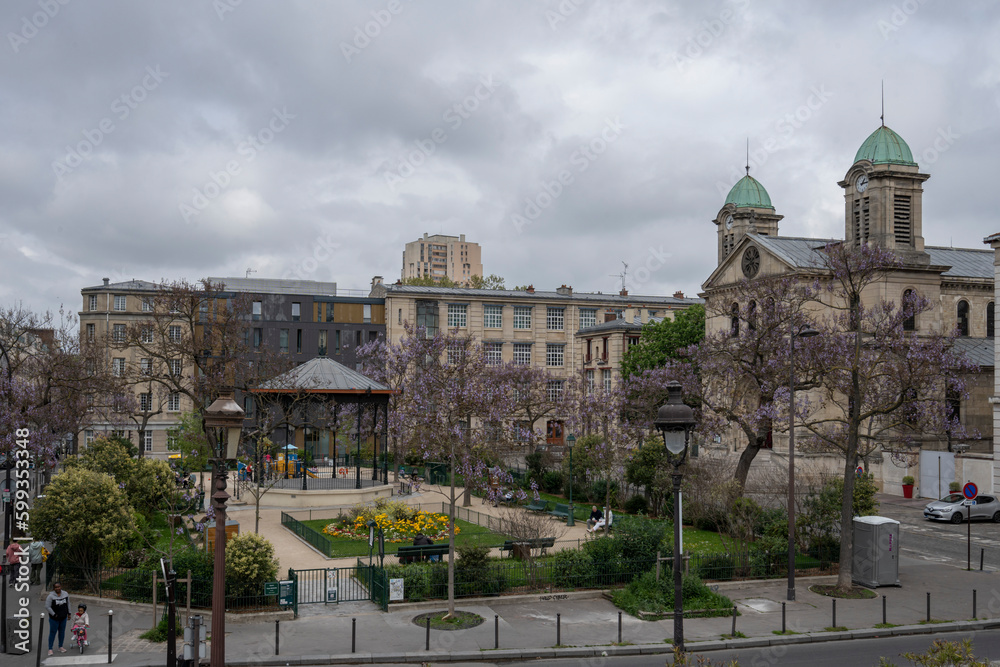 Fototapeta premium Paris, France - 05 01 2023: Flandres district. View of the Square Serge Reggiani and Church of Saint-Jacques-Saint-Christophe.