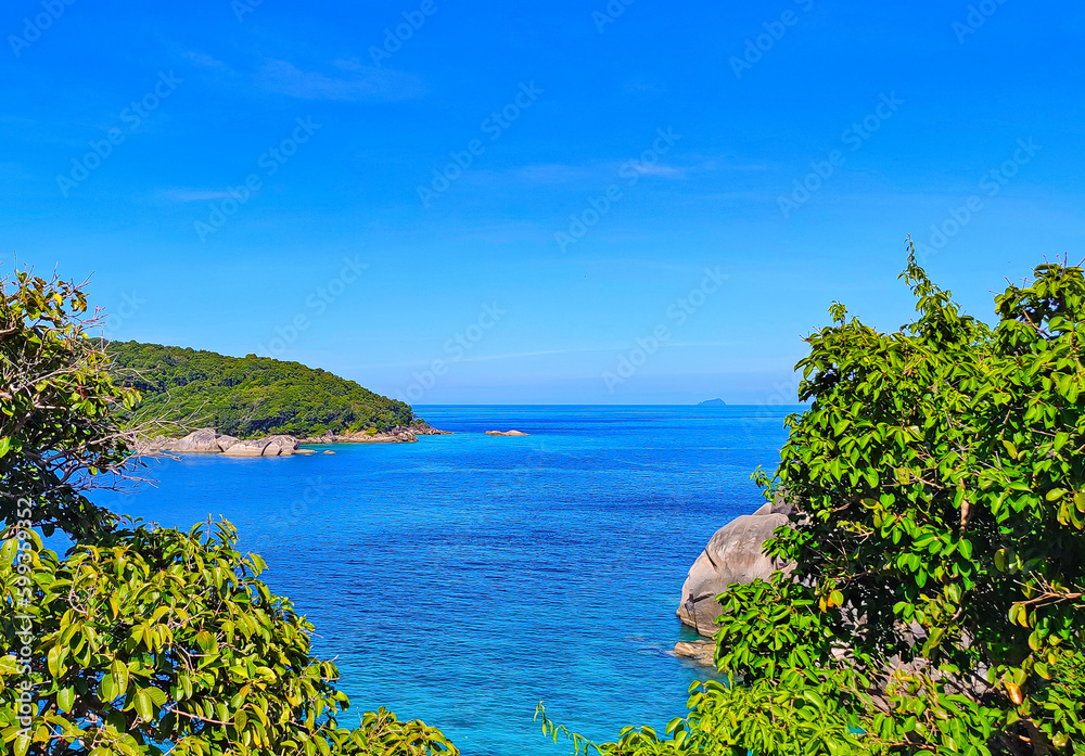 Beautiful view of the tropical sea with green rocks, blue sky, for postcards, posters, for tourists