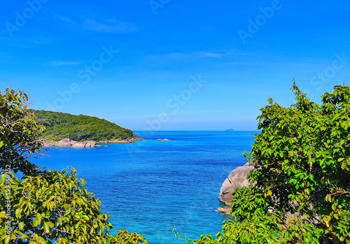 Beautiful view of the tropical sea with green rocks, blue sky, for postcards, posters, for tourists © Yelena