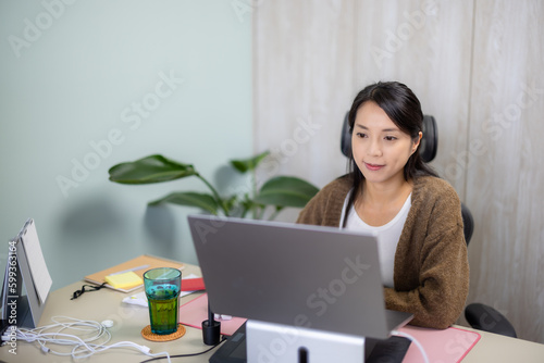 Woman work at home with her laptop computer