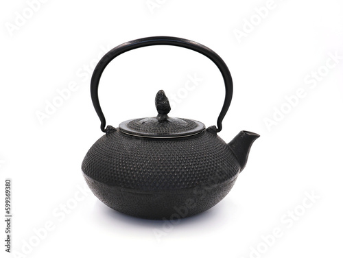 Black cast iron teapot isolated on white background.