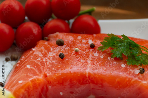 A large piece of salmon with tomatoes and spices