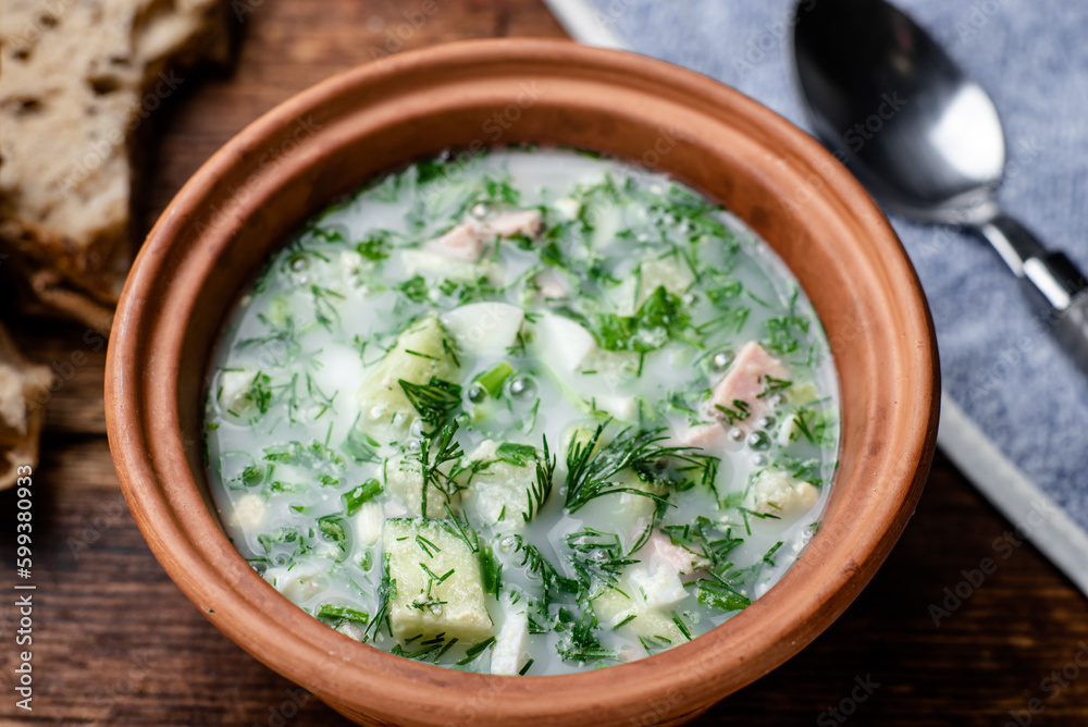 Okroshka, Russian cold soup on a wooden background. Okroshka, Russian cold soup on a wooden background.