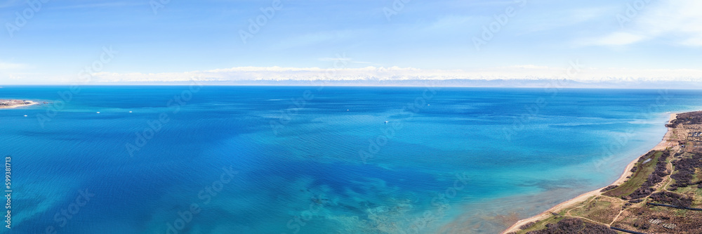 erial panoramic view of the vivid blue waters of Lake Issyk-Kul