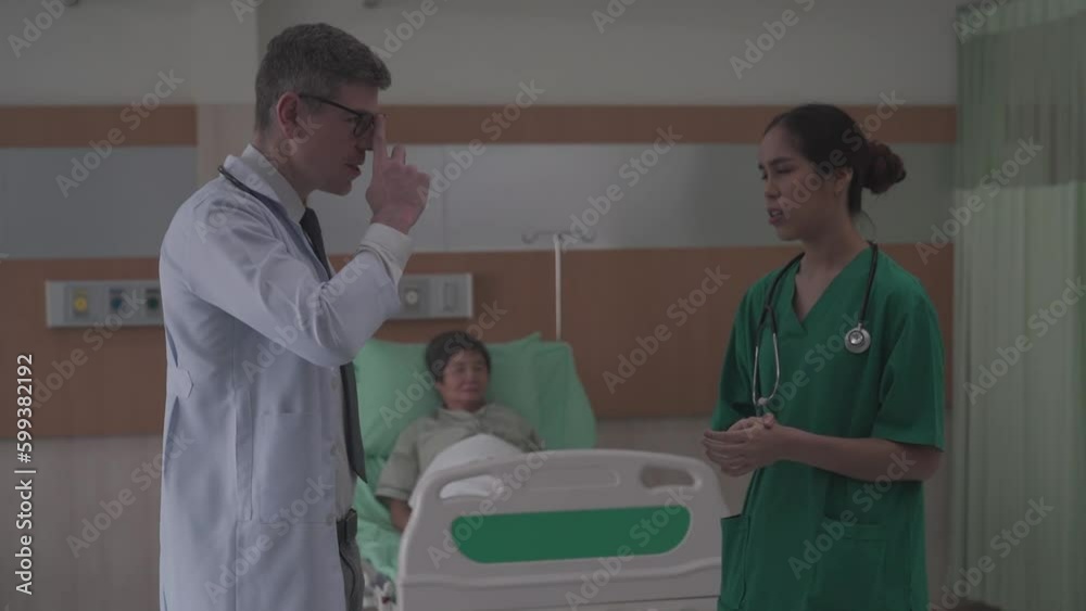 man and woman doctors having a discussion in a elderly patient room about status of the operation and medical.