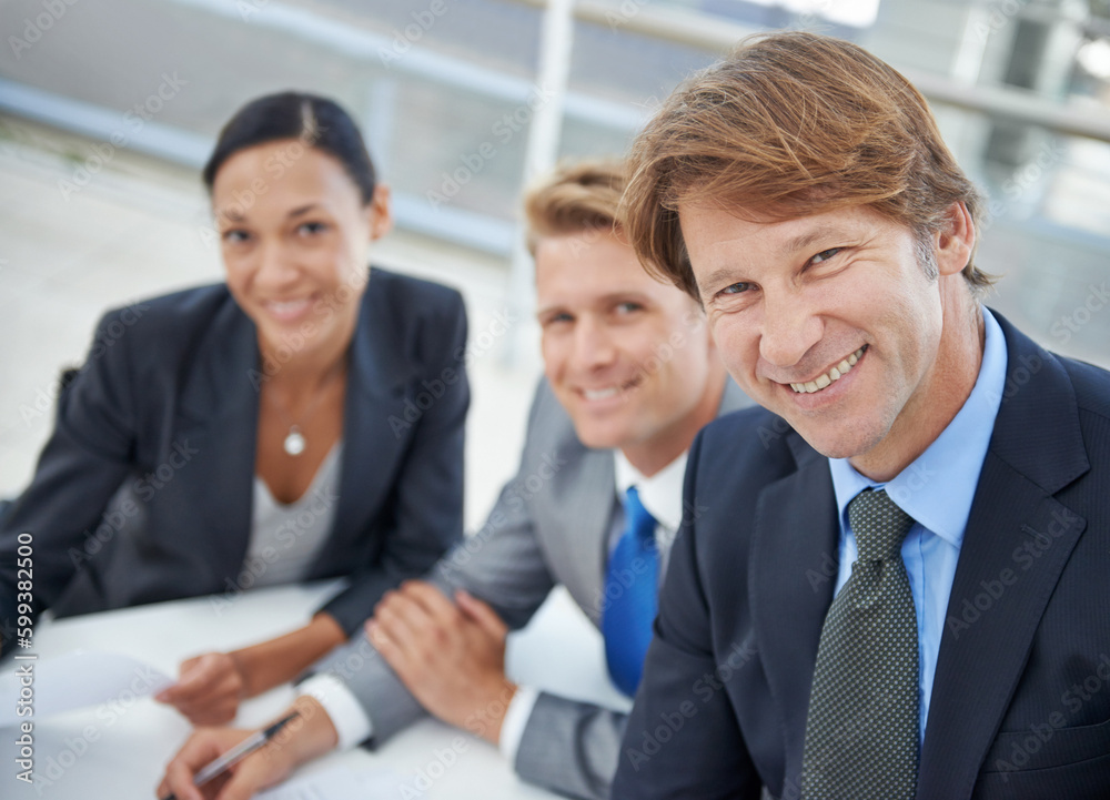 Offering their clients the most professional service. A group of business executives sitting at a conference table. Offering their clients the most professional service. A group of business executives sitting at a conference table.