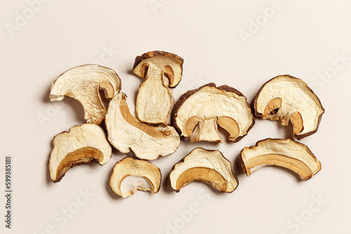 Minimal food pattern beige monochrome colors from dried slices of porcini, dehydrated food boletus mushrooms, top view, aesthetic texture flat lay. Natural forest white mushroom, healthy eating photo