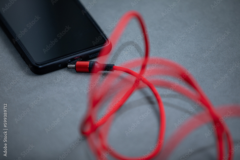 A view of a lying cell phone that is not wired to a charger. A view of a lying cell phone that is not wired to a charger.