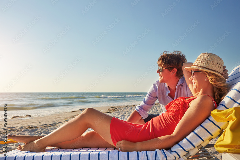 They know just where to go to cool off. an attractive young woman lying on a lounger at the beach.