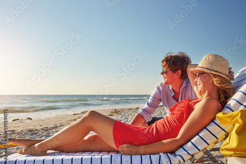They know just where to go to cool off. an attractive young woman lying on a lounger at the beach. © GR/peopleimages.com