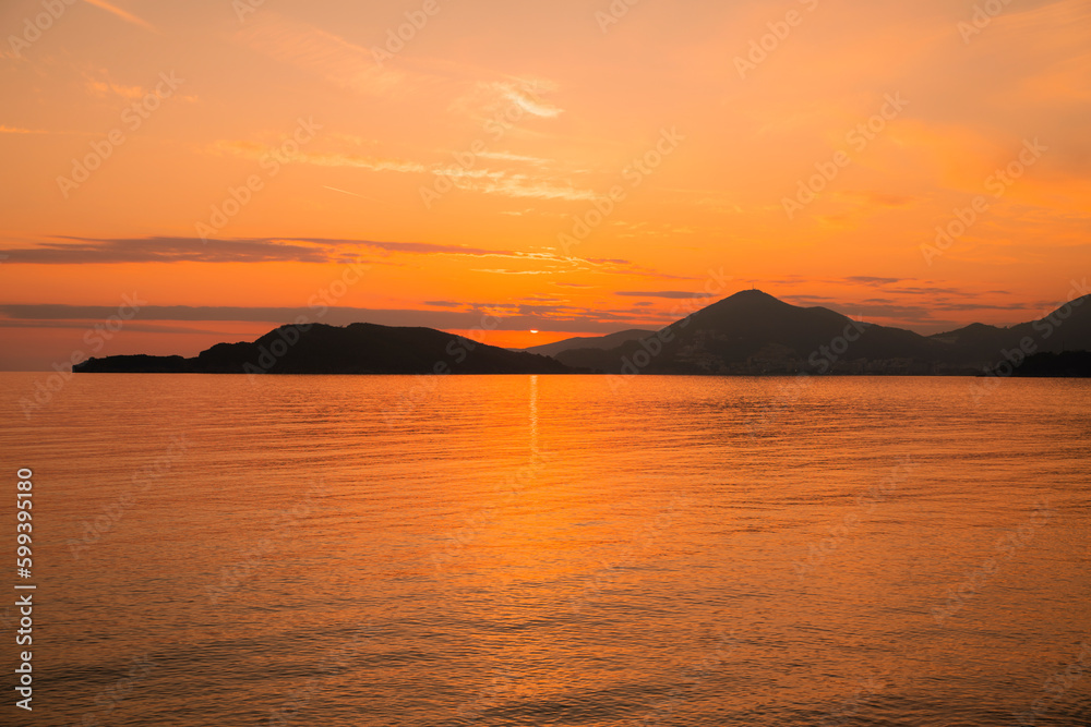 Golden sunset in Montenegro city of Budva on the beach of St. Stephen