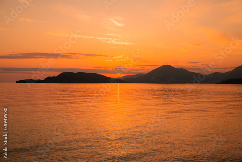 Golden sunset in Montenegro city of Budva on the beach of St. Stephen