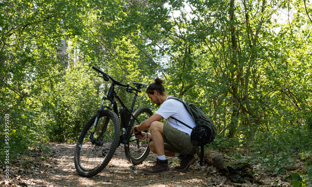 Man in forest with bicycle