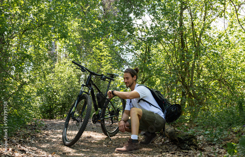 Man in forest with bicycle