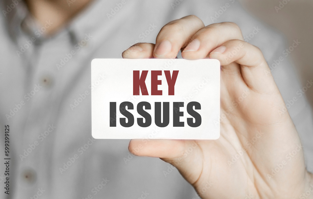 Card with text Key Issues in a man's hand Card with text Key Issues in a man's hand