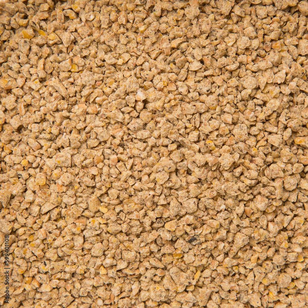 Looped Rotation of Compacted Wooden Sawdust Pellets with Small Brown Stones. - Natural Cat Litter Filler or Organic Fuel Looped Rotation of Compacted Wooden Sawdust Pellets with Small Brown Stones. - Natural Cat Litter Filler or Organic Fuel