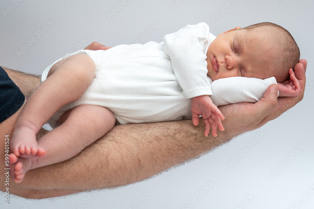 Father Holding sleeping Newborn Baby on his hand Father Holding sleeping Newborn Baby on his hand