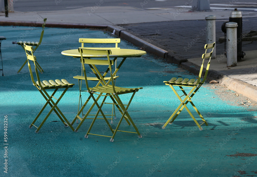 outdoor table and chairs with beam of light, fire hydrant, outdoor dining on painted sidewalk outdoor table and chairs with beam of light, fire hydrant, outdoor dining on painted sidewalk