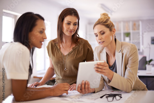 What do you guys think of this...Three female colleagues having a discussion while gathered around a digital tablet.