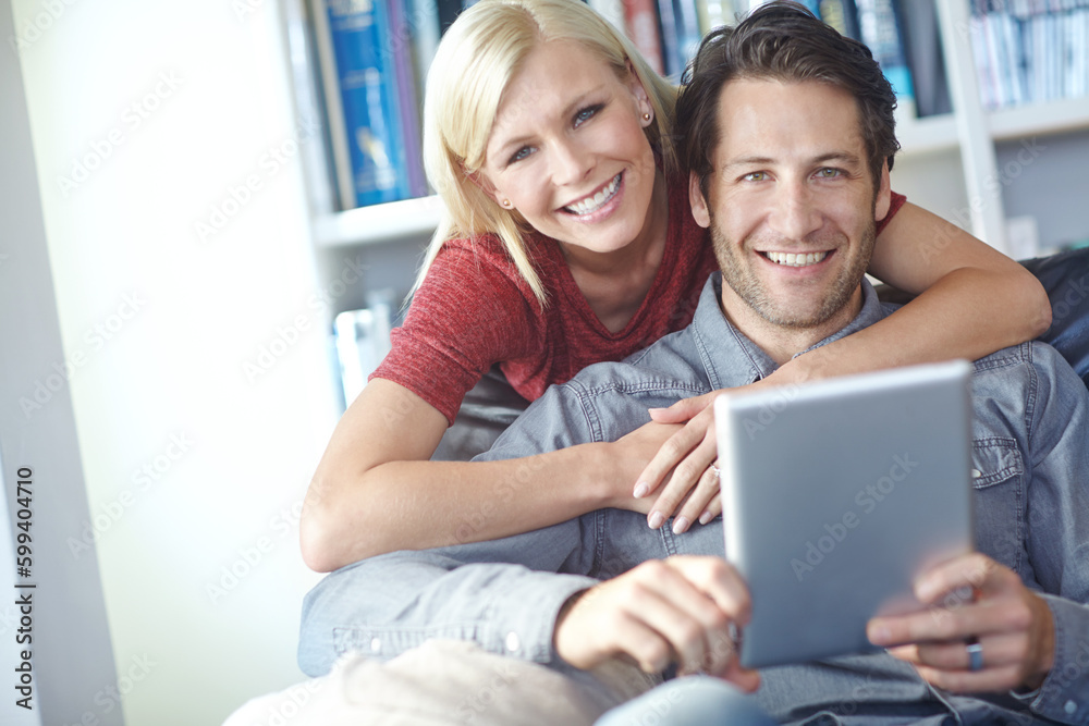 Planning a vacation is so easy online. Portrait of a young couple using a digital tablet. Planning a vacation is so easy online. Portrait of a young couple using a digital tablet.