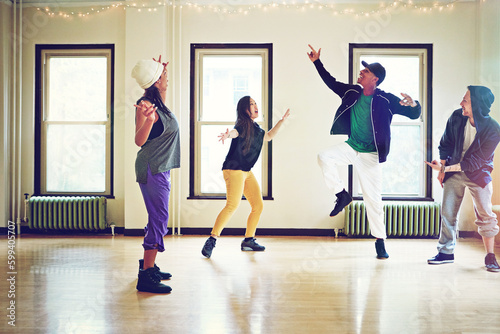 Dance moves that are all kinds of awesome. a group of young friends dancing together in a studio.