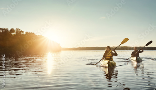Make memories on the water. a young couple kayaking on a lake outdoors.