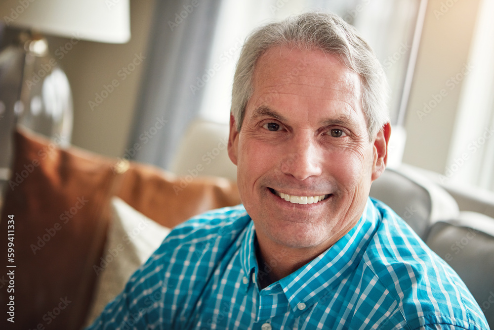 Its relaxation station after retirement. Portrait of a happy mature man relaxing on the sofa at home. Its relaxation station after retirement. Portrait of a happy mature man relaxing on the sofa at home.