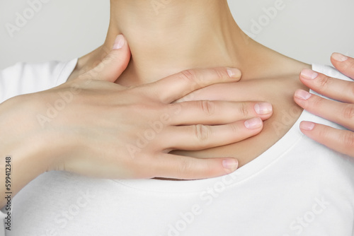 a woman makes herself a lymphatic drainage massage of the clavicular zone. self-massage, muscle relaxation, body care concept