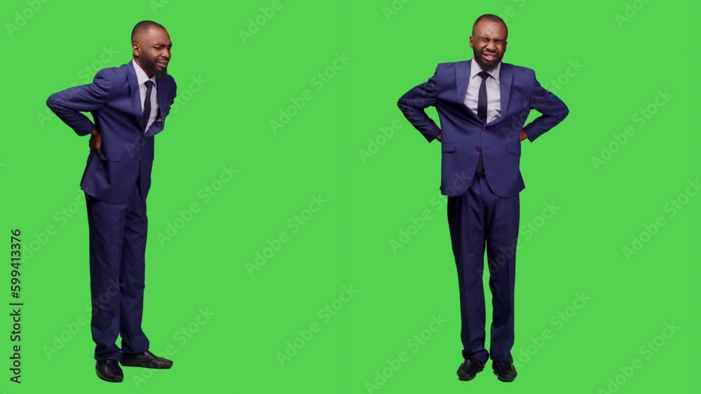 Male office worker suffering from spine pain in studio, dealing with backache and tension over full body greenscreen. Startup manager having backpain, unwell man in discomfort. Male office worker suffering from spine pain in studio, dealing with backache and tension over full body greenscreen. Startup manager having backpain, unwell man in discomfort.