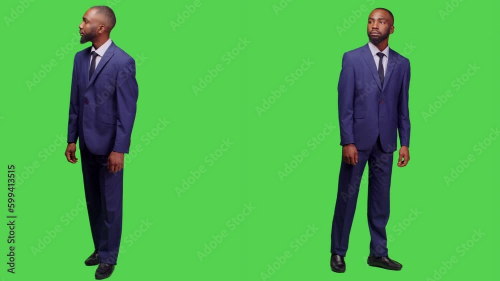 African american businessman looking around in studio, waiting for something and wearing office suit. Formal startup employee acting confident posing over full body greenscreen backdrop. African american businessman looking around in studio, waiting for something and wearing office suit. Formal startup employee acting confident posing over full body greenscreen backdrop.