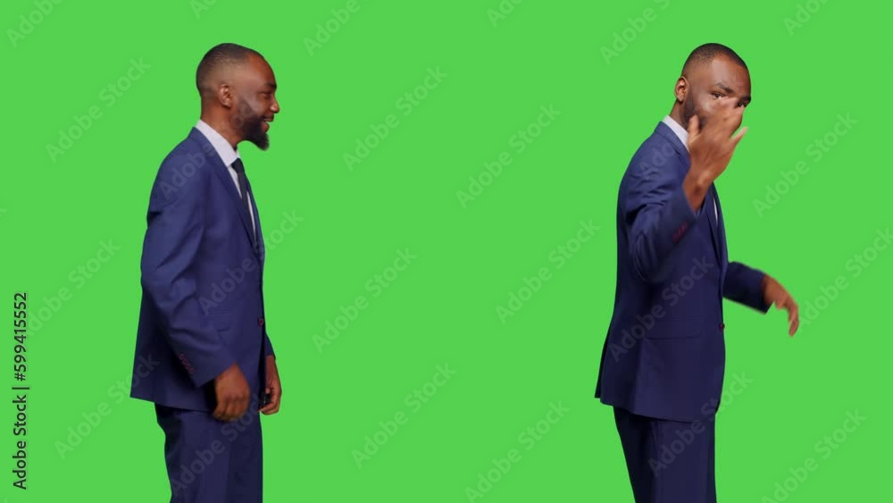 African american businessman asking someone to come, calling person over to sit next to him. Corporate employee in suit standing over isolated green screen background, confident adult. African american businessman asking someone to come, calling person over to sit next to him. Corporate employee in suit standing over isolated green screen background, confident adult.