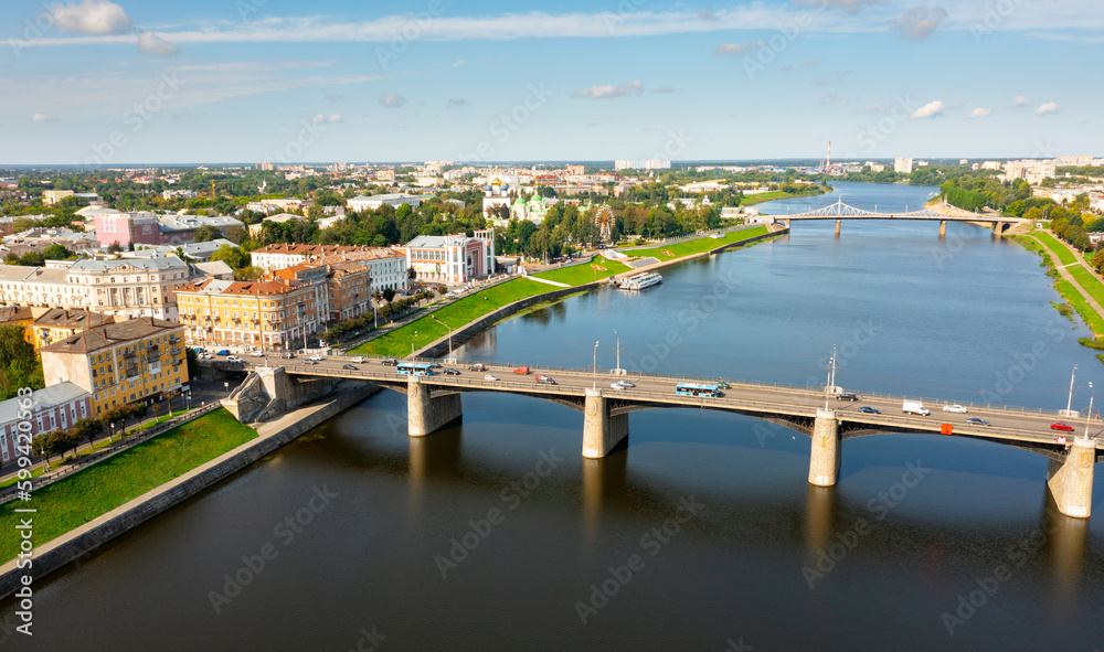Scenic cityscape of Tver city located on Volga river overlooking residential areas and bridges on sunny summer day, Russia