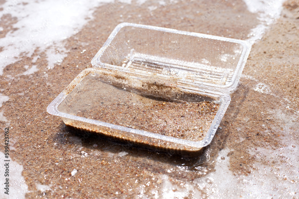 Plastic food container on the beach Plastic food container on the beach