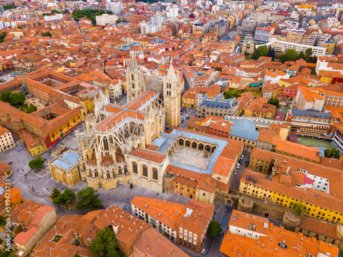View from drone of reddish roofs of residential buildings and medieval Gothic Cathedral in Spanish city of Leon .. photo