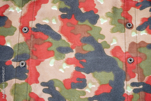 Camouflage background. Military uniform. War wallpaper. Disguise. Protection. Khaki. Soldier textiles. The texture of the spots. Camouflage colors