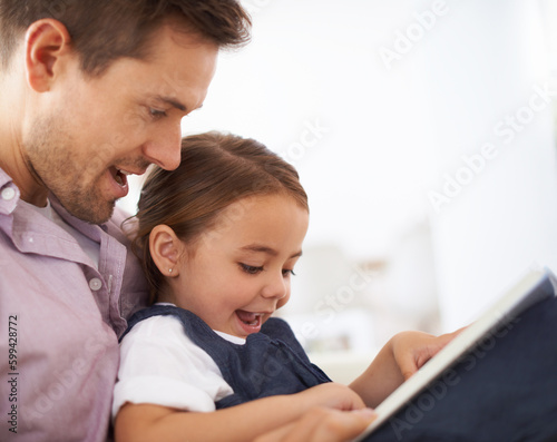 Getting lost in a fairytale. Closeup shot of a young father reading a book with his daughter.