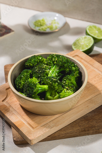 A bowl of blanched cooked broccoli trees
