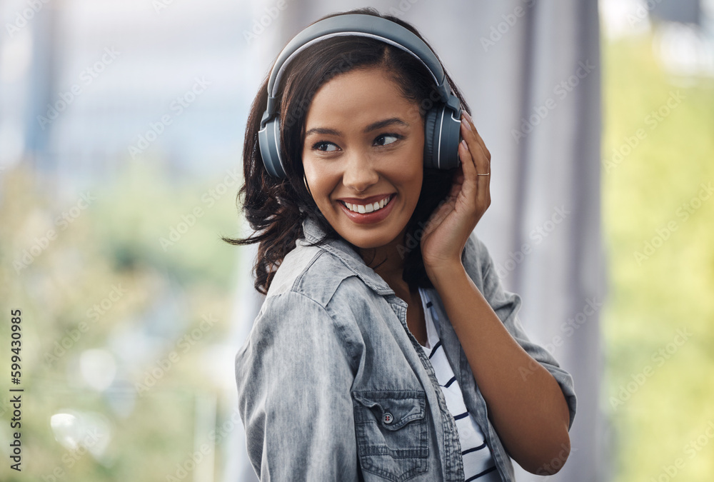 Its just me and my favourite beats. a young woman wearing headphones while listening to music at home. Its just me and my favourite beats. a young woman wearing headphones while listening to music at home.