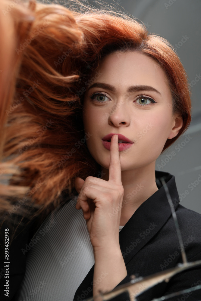 Woman looking at herself in broken mirror, top view Woman looking at herself in broken mirror, top view