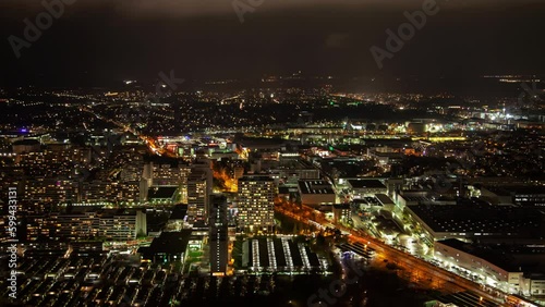 Wallpaper Mural Aerial night timelapse of Munich cityscape, displaying the illuminated skyline, clouds, and Bavarian architecture in autumn. Torontodigital.ca